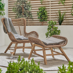 Outdoor chair with ottoman outlet that slides underneath